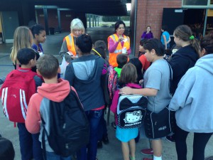 Students at Thomas Edison Language Institute receive stickers and backpack reflectors.